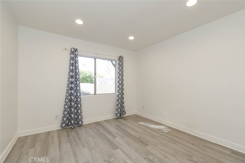 The secondary bedroom has recess ceiling lights and laminate flooring. Clean and ready to move-in. - 23472 Cambridge Road 297, Yorba Linda CA 92887 - photo 21