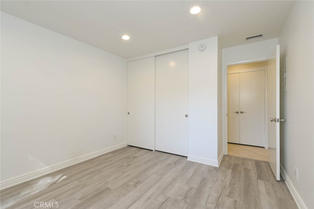 Good-size closet in the secondary bedroom. The double doors across the hallway open up to more closet space. - 23472 Cambridge Road 297, Yorba Linda CA 92887 - photo 22