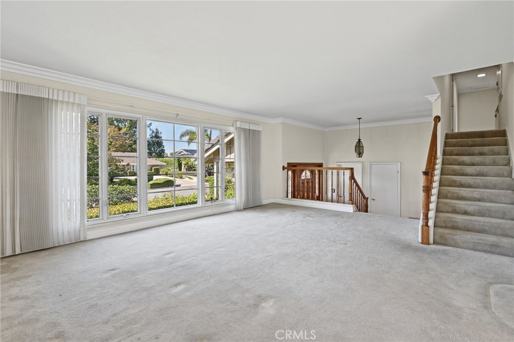 The spacious living room has and incredible large window. - 5062 W Knoll Drive, Yorba Linda CA 92886 - photo 12