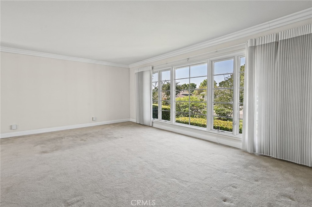 The spacious living room has and incredible large window. - 5062 W Knoll Drive, Yorba Linda CA 92886 - photo 13