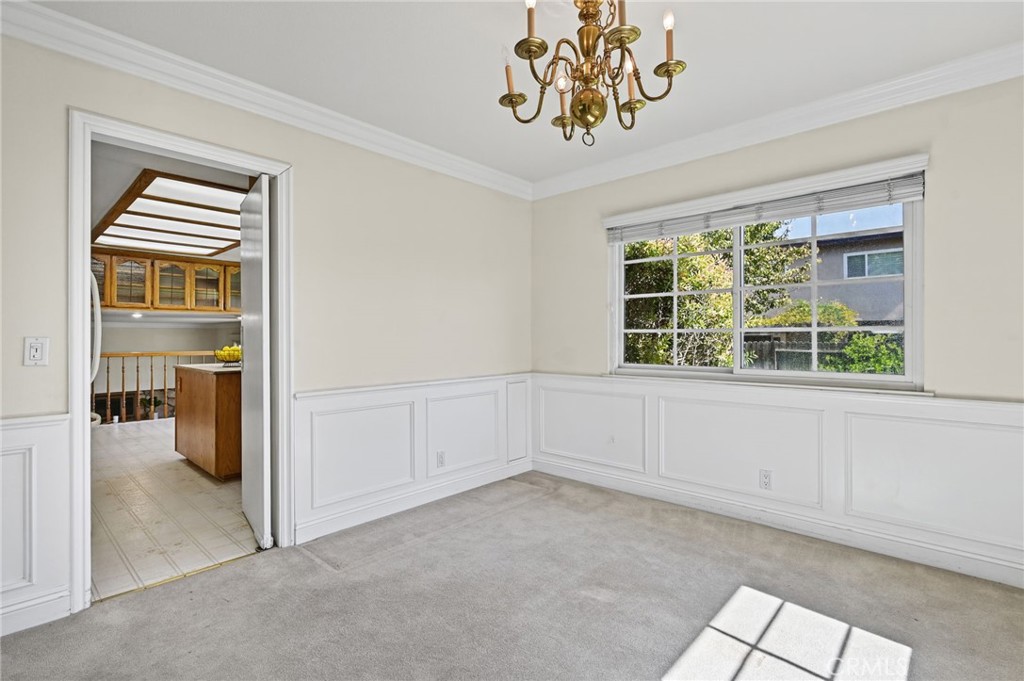 The dining room features gorgeous wainscoting, crown molding, and views other backyard - 5062 W Knoll Drive, Yorba Linda CA 92886 - photo 17