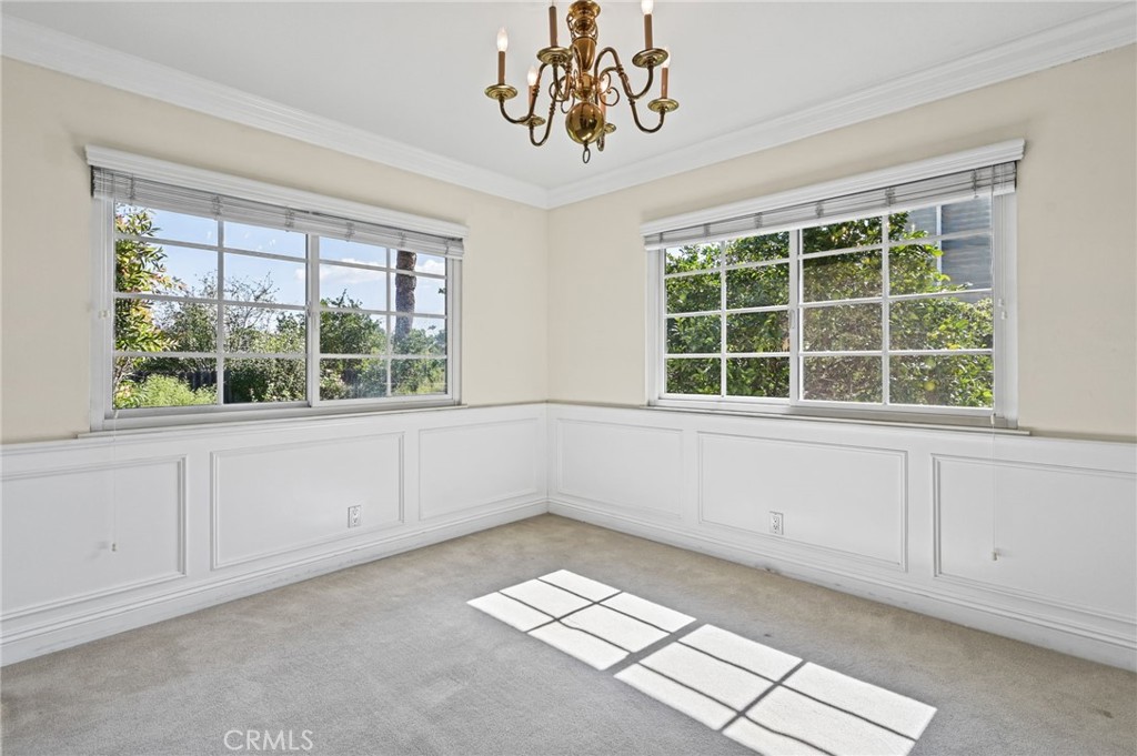 The dining room features gorgeous wainscoting, crown molding, and views other backyard - 5062 W Knoll Drive, Yorba Linda CA 92886 - photo 18