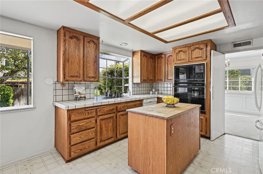 The kitchen with 2 garden windows and a kitchen island - 5062 W Knoll Drive, Yorba Linda CA 92886 - photo 23