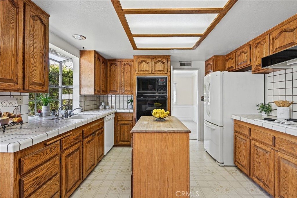 The kitchen has lots of storage space and a kitchen island - 5062 W Knoll Drive, Yorba Linda CA 92886 - photo 24