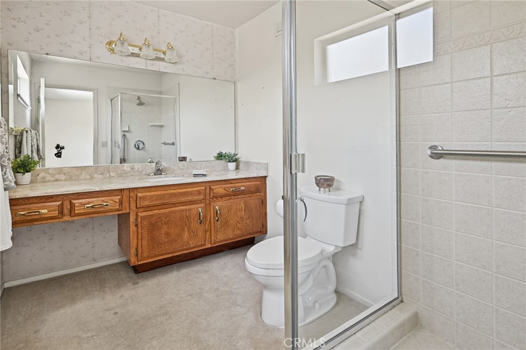 The Primary Bathroom has a long vanity and a walk in shower. - 5062 W Knoll Drive, Yorba Linda CA 92886 - photo 35