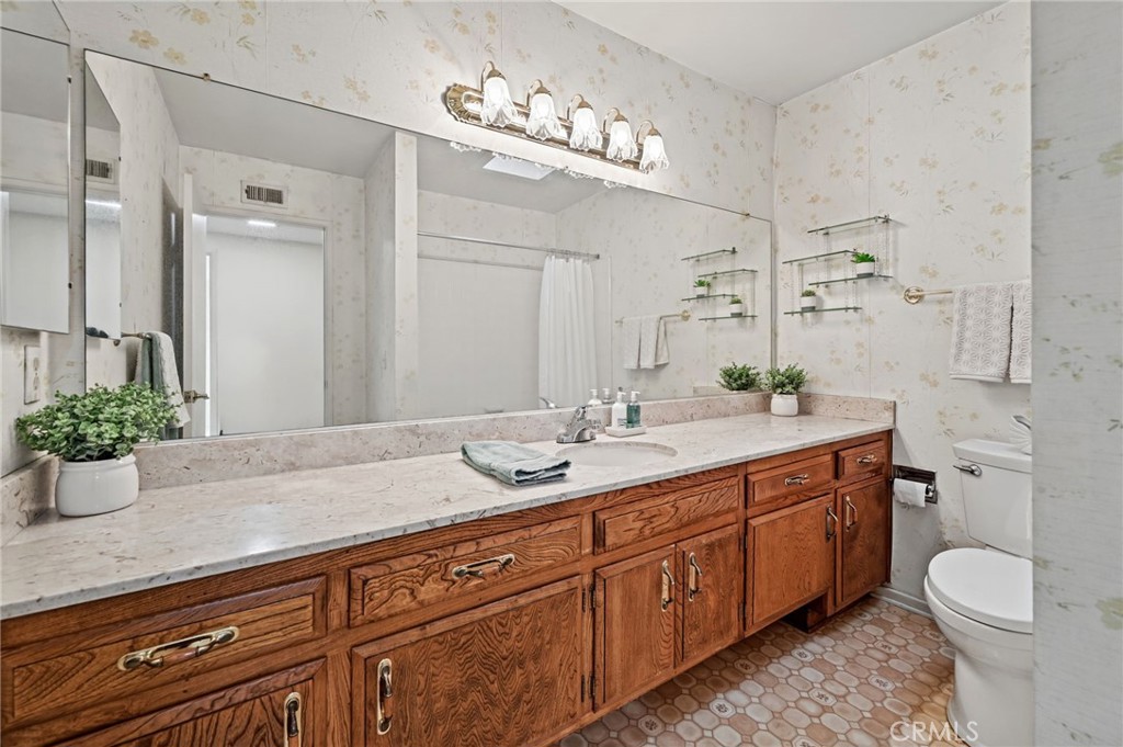 The upstairs hallway bathroom has a long vanity and a tub/shower combination - 5062 W Knoll Drive, Yorba Linda CA 92886 - photo 38
