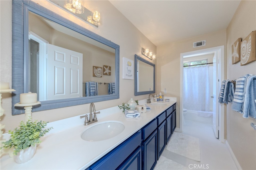 Secondary bedrooms share this full hall bath with double vanity and privacy door to commode and tub/shower room. - 5505 Green Hollow Lane, Yorba Linda CA 92887 - photo 15
