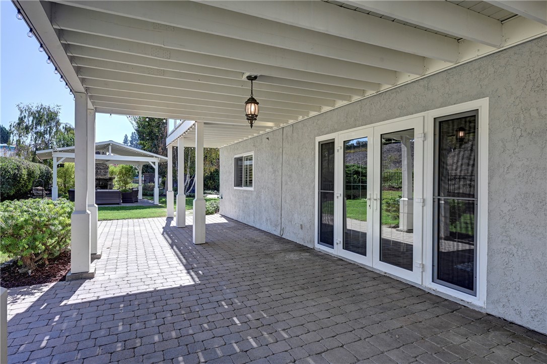 Downstairs patio with French doors to the den and some of the bedrooms. - 5561 Orchard, Yorba Linda CA 92886 - photo 20