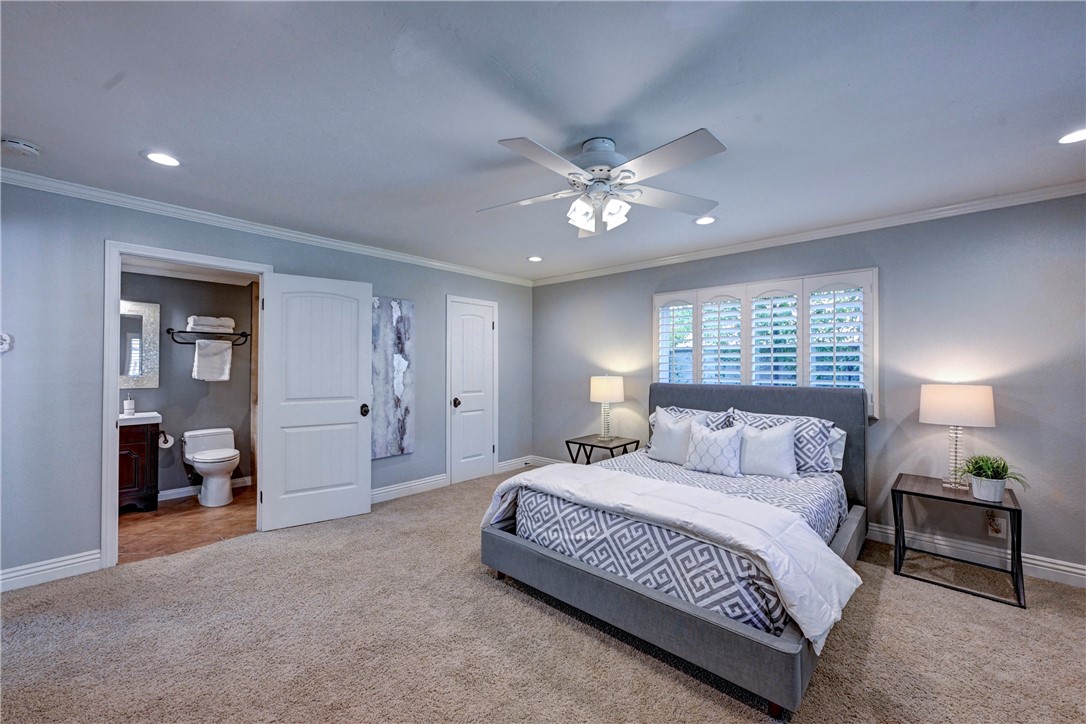 Downstairs primary suite with recessed lighting, lighted ceiling fan and shutters on the windows. - 5561 Orchard, Yorba Linda CA 92886 - photo 29