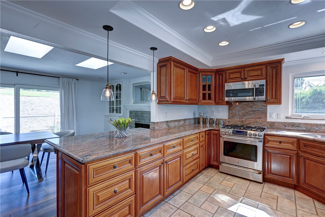 Stainless steel appliances, easy care tile flooring and rich wood cabinetry completes this kitchen. - 5561 Orchard, Yorba Linda CA 92886 - photo 37