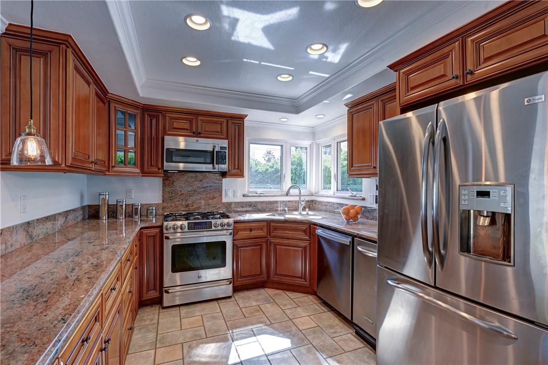 Windows over the sink and recessed lighting in this bright kitchen. - 5561 Orchard, Yorba Linda CA 92886 - photo 38
