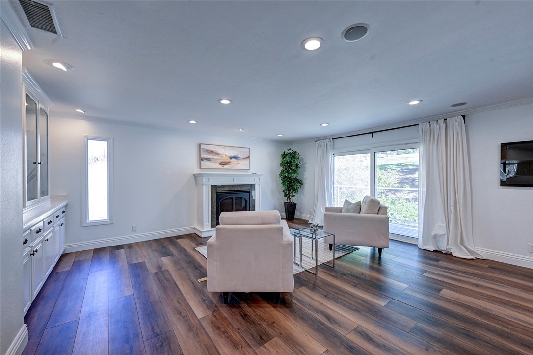 Note the electronic fireplace, built in cabinetry on the left and wide slider to the outside deck on the right. - 5561 Orchard, Yorba Linda CA 92886 - photo 46