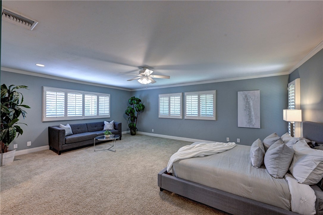 The large primary suite has recessed lighting, lighted ceiling fan, shutters and carpeted flooring. - 5561 Orchard, Yorba Linda CA 92886 - photo 50